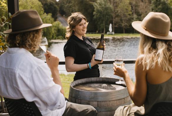 Waitress pours guests glasses of wine at Ampersand Estates Winery, Australia’s South West, Western Australia © Tourism Australia