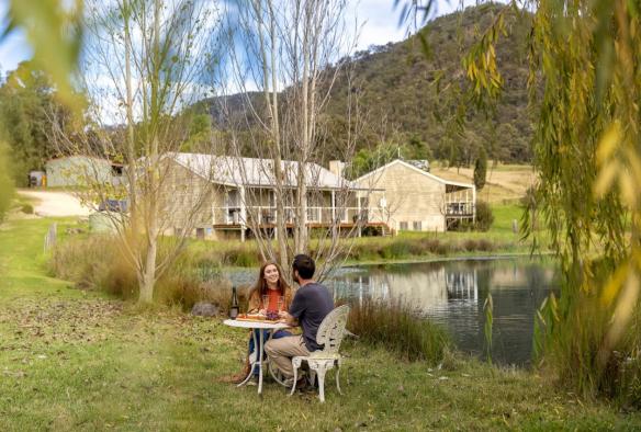 Couple dining by a lake, Starline Alpaca Farm, Broke, New South Wales © Tourism Australia
