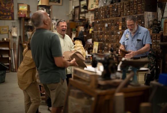 Tour group laughing at a hat shop with Real Byron Tours, Tweed, New South Wales © Tourism Australia