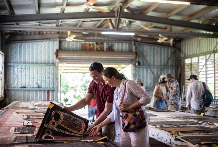 A couple admiring Aboriginal artwork, Tiwi Islands, Top End, Northern Territory © Tourism NT/Helen Orr 2021
