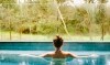 View through trees towards a pool and cabana surrounded by greenery at Gaia Retreat & Spa, Byron Bay, New South Wales © Gaia Retreat & Spa