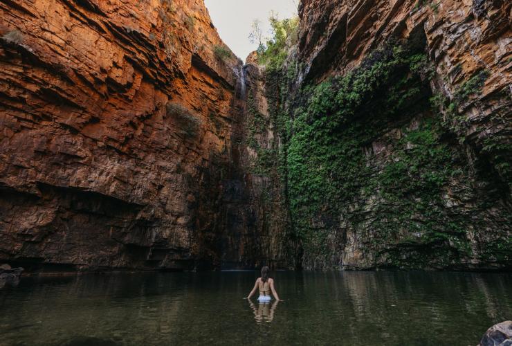 A person swimming in a natural waterhole, Emma Gorge, El Questro Wilderness Park © Tourism Western Australia