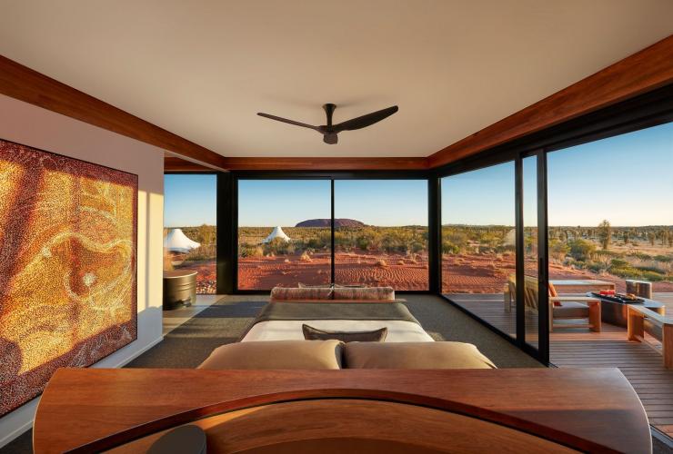 The interior of a luxurious hotel room overlooking an outback landscape with a red rock monolith in the distance, Longitude 131, Yulara, Northern Territory © Beckons Journeys