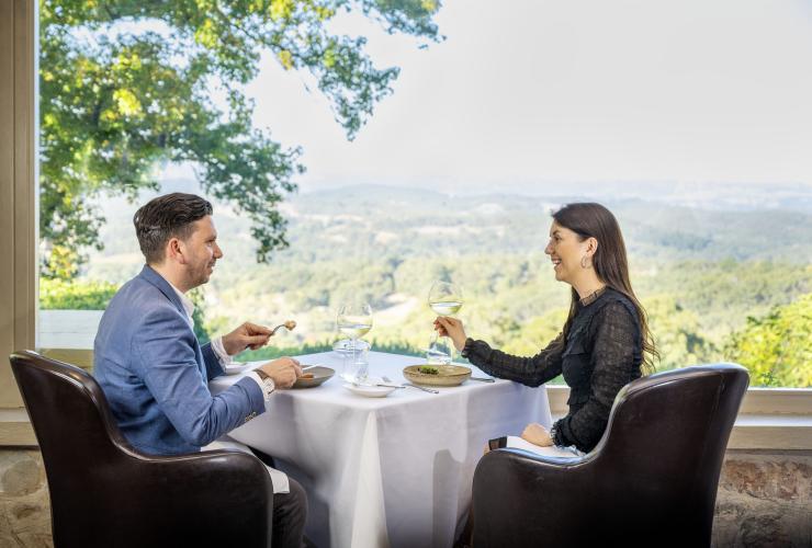 A couple dining with rolling hills in the background, Mount Lofty House Estate, Crafers, South Australia © Tourism Australia