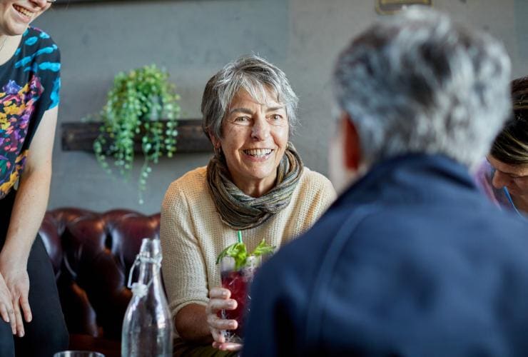 Woman smiling with cocktail, Gilbert Wines, Australia © Susan McCabe t/as Busy Blue Bus Tours