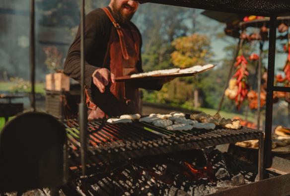 Chef cooking over coals at Osborn House, Southern Highlands, New South Wales © Osborn House