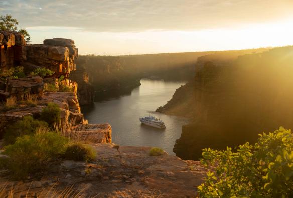Aerial view of a small cruise ship surrounded by cliffs, True North, King George River, Kimberley, Western Australia © True North