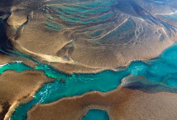 Aerial view of the swirling blue waters of Montgomery Reef in the Kimberley, Western Australia © Lauren Bath