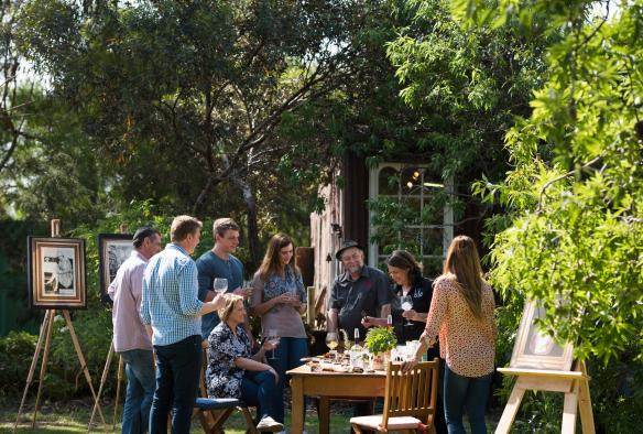 Group gathered around a table in a garden sampling spirits at Kangaroo Island Spirits Distillery, Kangaroo Island, South Australia © Adam Bruzzone