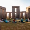 A group of women sitting in a circle on the grass, surrounded by large grey boulders in Esperance, Western Australia © Tourism Australia