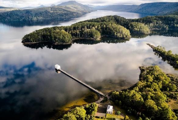 Aerial of the Pumphouse Point floating accommodation  and greenery around Lake St Clair, Tasmania © Tourism Tasmania