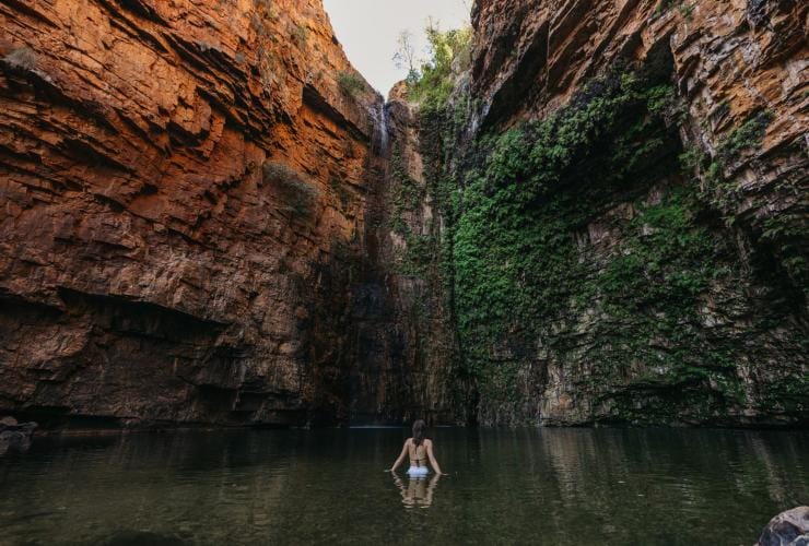 A person swimming in a natural waterhole, Emma Gorge, El Questro Wilderness Park © Tourism Western Australia