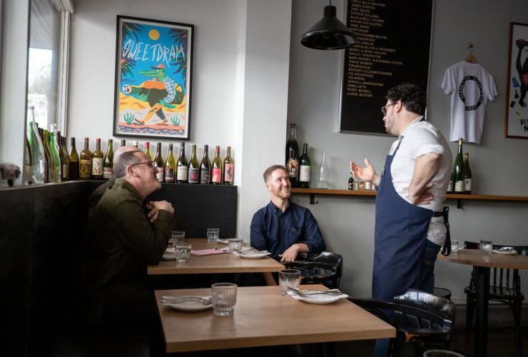 A chef speaking with a table of guests at a restaurant, Localing Tours, Melbourne, Victoria © Tourism Australia
