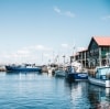 Blue boats sitting on the calm water of Hobart Harbour in Hobart, Tasmania © Adam Gibson