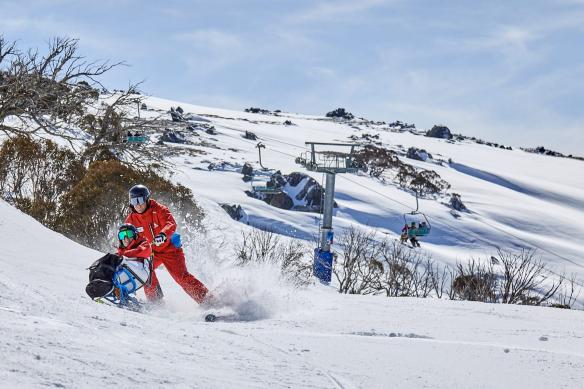 A visitor to Thredbo uses a sit ski for accessible skiing, Snowy Mountains, New South Wales © Tourism Australia