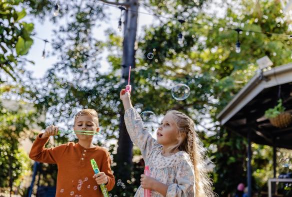 Two children play with bubbles at The Windmill Cafe, Bargara, Queensland © Tourism and Events Queensland