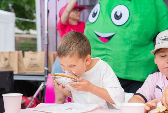 Child participating in a pie eating contest, Hawkesbury, New South Wales © Hawkesbury City Council