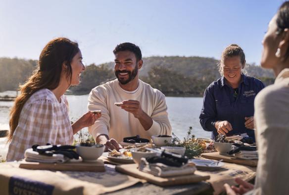 Couple enjoying fresh oysters at Broadwater Oysters, Pambula, New South Wales © Destination NSW