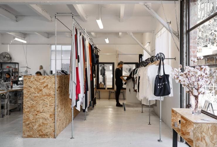 A person browsing a light-filled clothing store, Citizen Wolf, Sydney, New South Wales © Jason de Plater