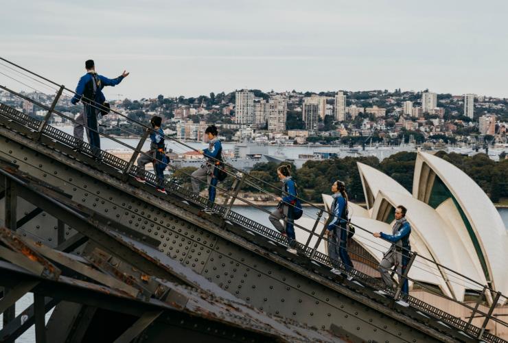 A group of people climbing a steel arch bridge during the Burrawa Climb on the Sydney Harbour Bridge, Sydney, New South Wales © Destination NSW