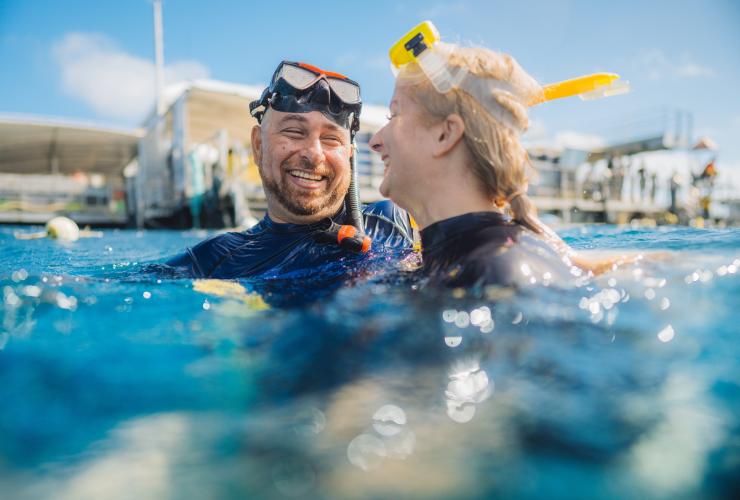 Wheelchair user and his partner floating above Agincourt Reef with Quicksilver Cruises, Great Barrier Reef, Queensland © Tourism and Events Queensland