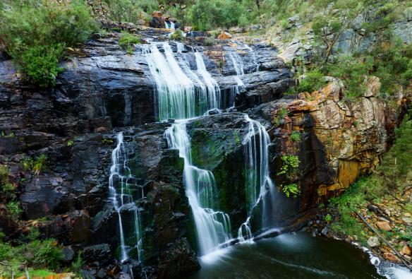 A large waterfall surrounded by green bushland at Ambush Grampians, Mackenzie Falls, Grampians National Park, Victoria © Tourism Australia/Visit Victoria 