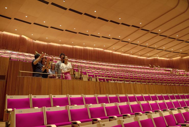 A tour group sits inside the theatre at the Sydney Opera House, Sydney, New South Wales © Tourism Australia 