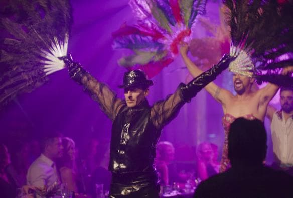 Dancers performing on stage with arms outstretched holding fans beneath purple stage lights during Open Season Music Series, Fortitude Valley, Brisbane, Queensland © Tourism and Events Queensland
