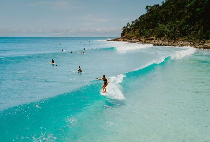 Surfer catching a wave at Noosa National Park, QLD © Tourism and Events Queensland