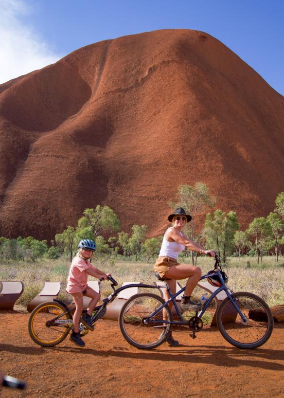 Mother and daughter riding a double bike around Uluru, Uluru-Kata Tjuta National Park, Northern Territory © Tourism NT/Trip in a Van