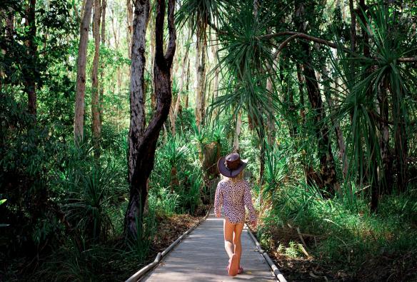 Young girl walking on a boardwalk through the forest to Maguk, Kakadu National Park, Northern Territory © Tourism NT/Kate Flowers