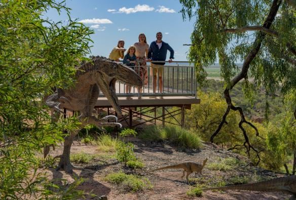 A family looking out at a dinosaur replica in the outback at the Australian Age of Dinosaurs, Winton, Queensland © Tourism and Events Queensland