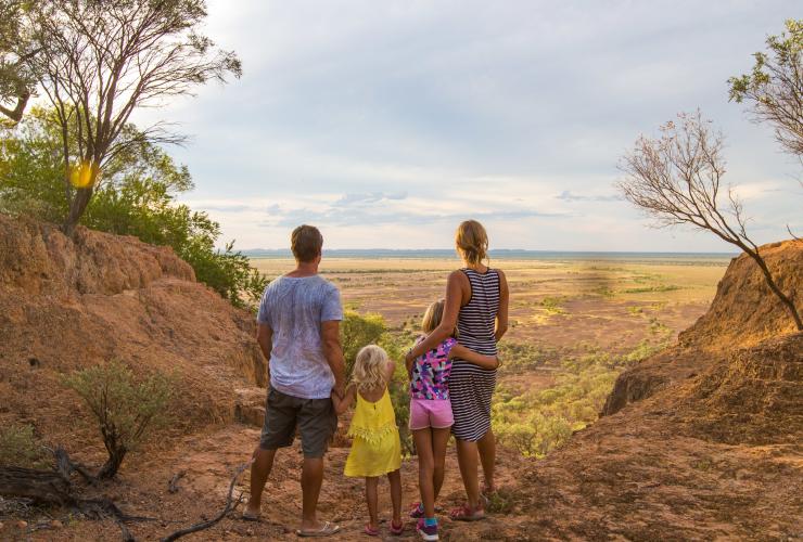 A family looking out at a view of the outback from the Australian Age of Dinosaurs museum, Winton, Queensland © Tourism and Events Queensland