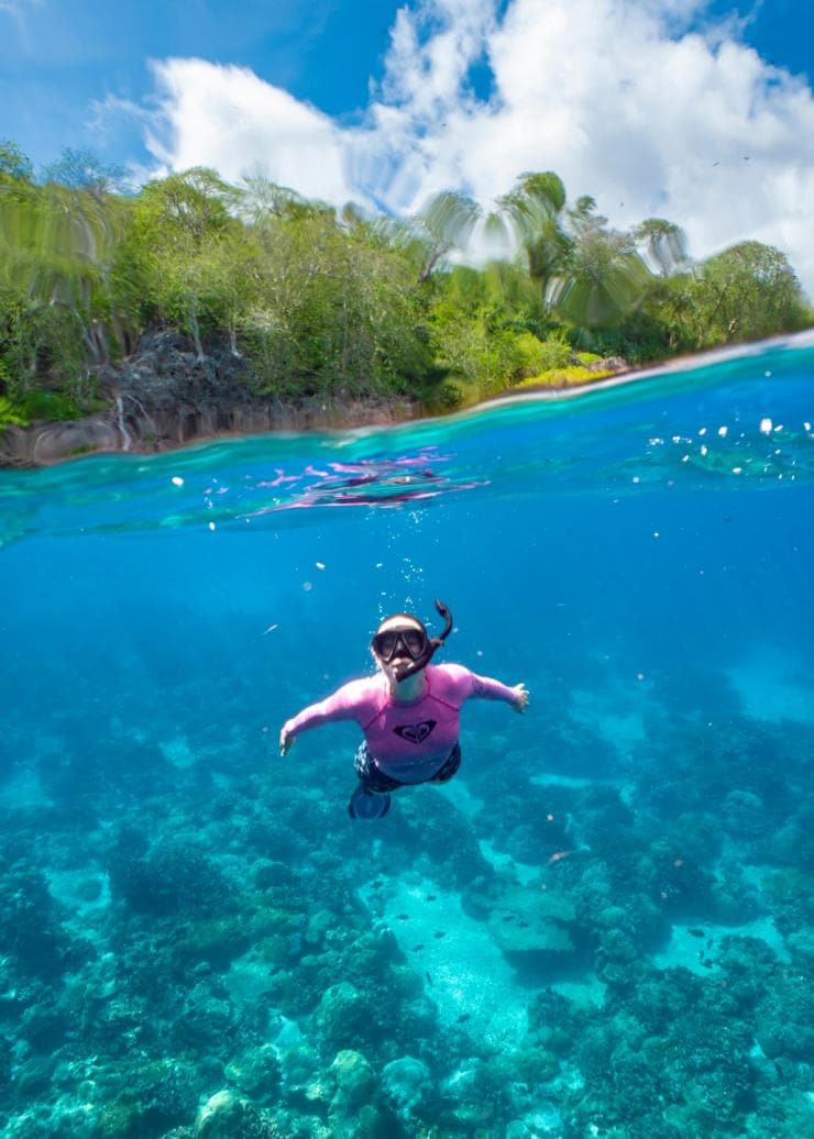 Woman snorkelling in clear blue water during a tour with Christmas Island Fishing & Adventure Tours, Christmas Island, Western Australia © Chris Bray