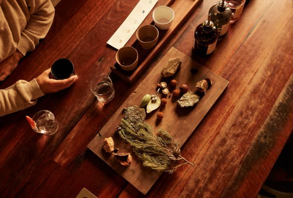 Aerial view of a table with distilling ingredients and glasses of spirits at Applewood Distillery, Adelaide Hills,South Australia © South Australian Tourism Commission