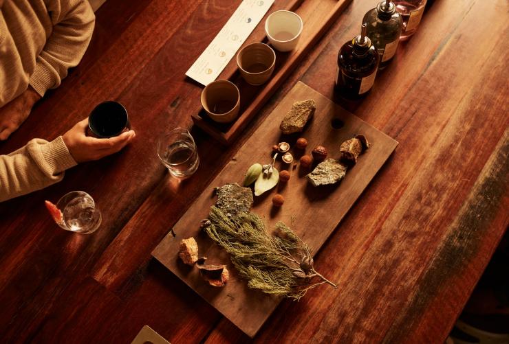 Aerial view of a table with distilling ingredients and glasses of spirits at Applewood Distillery, Adelaide Hills,South Australia © South Australian Tourism Commission