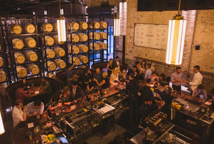 Aerial view of a large group gathered around the bar sipping cocktails at Archie Rose, Sydney, New South Wales © Archie Rose