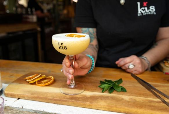 Close up of a bartender passing a cocktail across the bar at Kangaroo Island Spirits, Kangaroo Island, South Australia © South Australian Tourism Commission