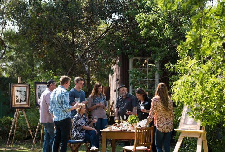 Group gathered around a table in a garden sampling spirits at Kangaroo Island Spirits Distillery, Kangaroo Island, South Australia © Adam Bruzzone