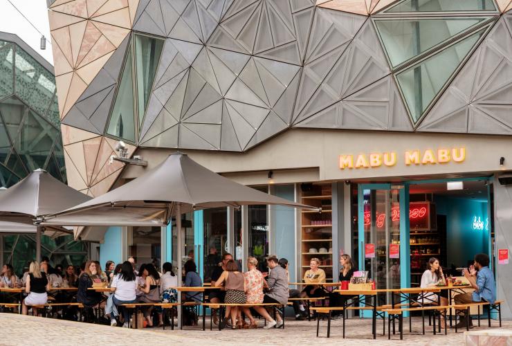 Outdoor tables and umbrellas at Big Esso by Mabu Mabu, Melbourne, Victoria © Visit Victoria 
