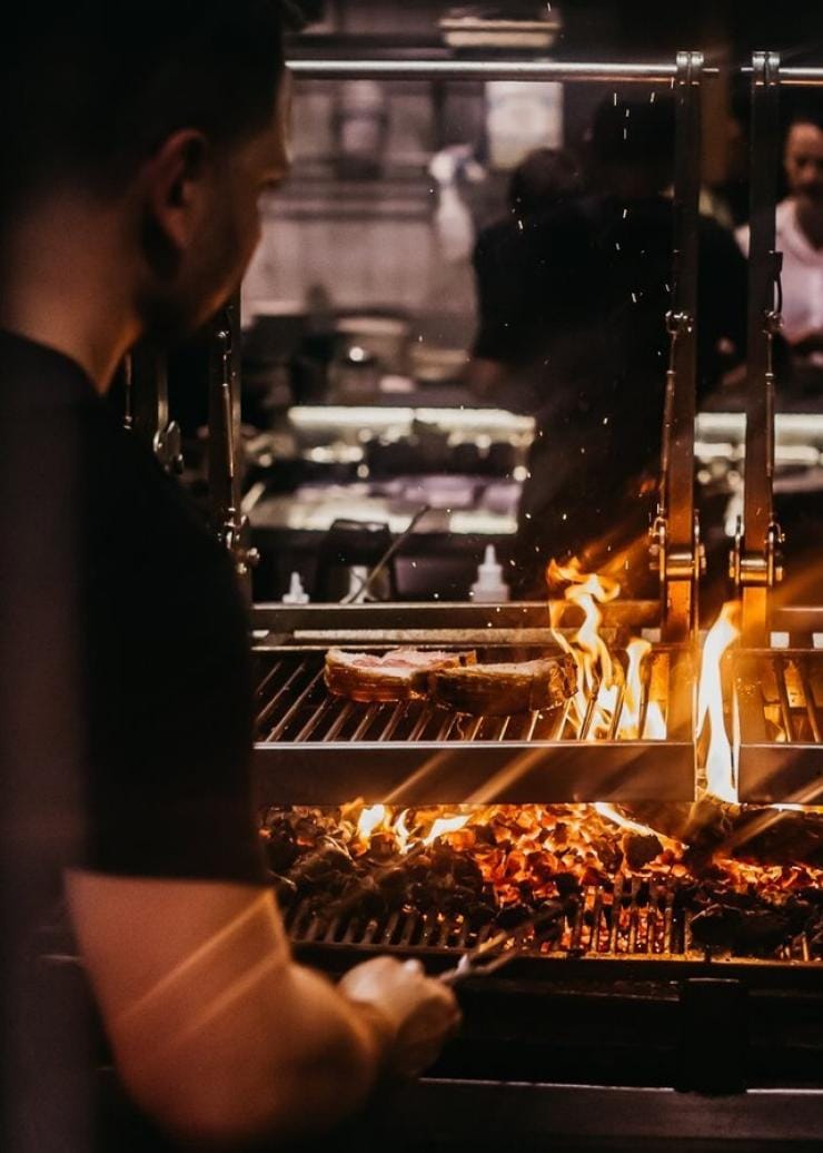 Chef Lennox Hastie cooking over fire at Firedoor, Surry Hills, New South Wales © Firedoor 