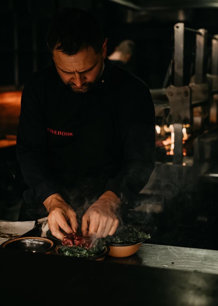 Chef Lennox Hastie plating up a dish at Firedoor, Surry Hills, New South Wales © Nikki To 
