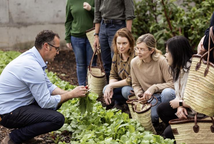 A group enjoys a garden tour at The Agrarian Kitchen, New Norfolk, Tasmania © Tourism Australia 
