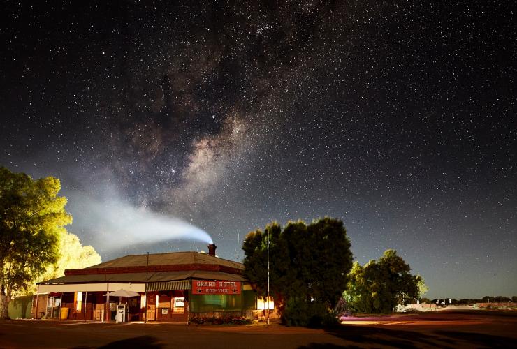 A small venue beneath a blanket of stars in the night sky at the Grand Hotel Kookynie, Kookynie, Western Australia © Tourism Western Australia