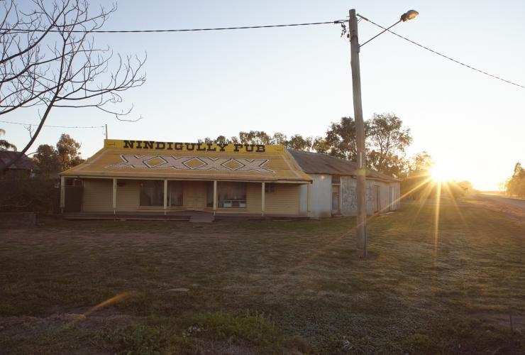 Exterior of a building with a yellow roof reading “Nindigully Pub”, Nindigully, Queensland © Tourism and Events Queensland 