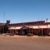  A pink building with a painted sign reading "Pink Roadhouse Oodnadatta", Flinders Ranges & Outback, South Australia © South Australia Tourism Commission