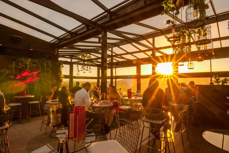 The setting sun shines through large glass windows at Howling Moon, Canberra, Australian Capital Territory © VisitCanberra