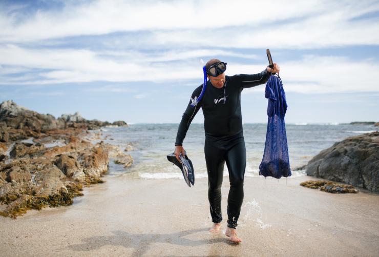 Man walking out of the ocean with his seafood catch with Australian Coastal Safaris, Port Lincoln, South Australia © Robert Lang/Australian Coastal Safaris