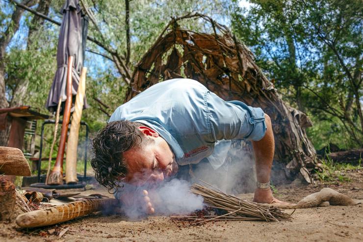 Indigenous guide starting a fire with twigs on a tour with Koomal Dreaming, Margaret River, Western Australia © Tourism Australia