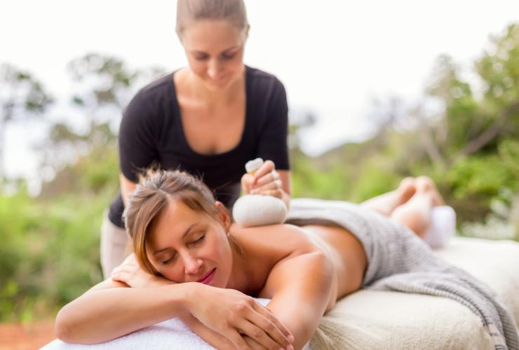 A guest laying down relaxing as she receives a massage treatment outside among bushland at Injidup Spa Retreat, Yallingup, Margaret River Region, Western Australia © LANEWAY Photography